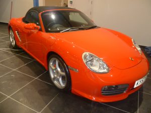 Red Porsche glints in a showroom after valet from mmvaleting.