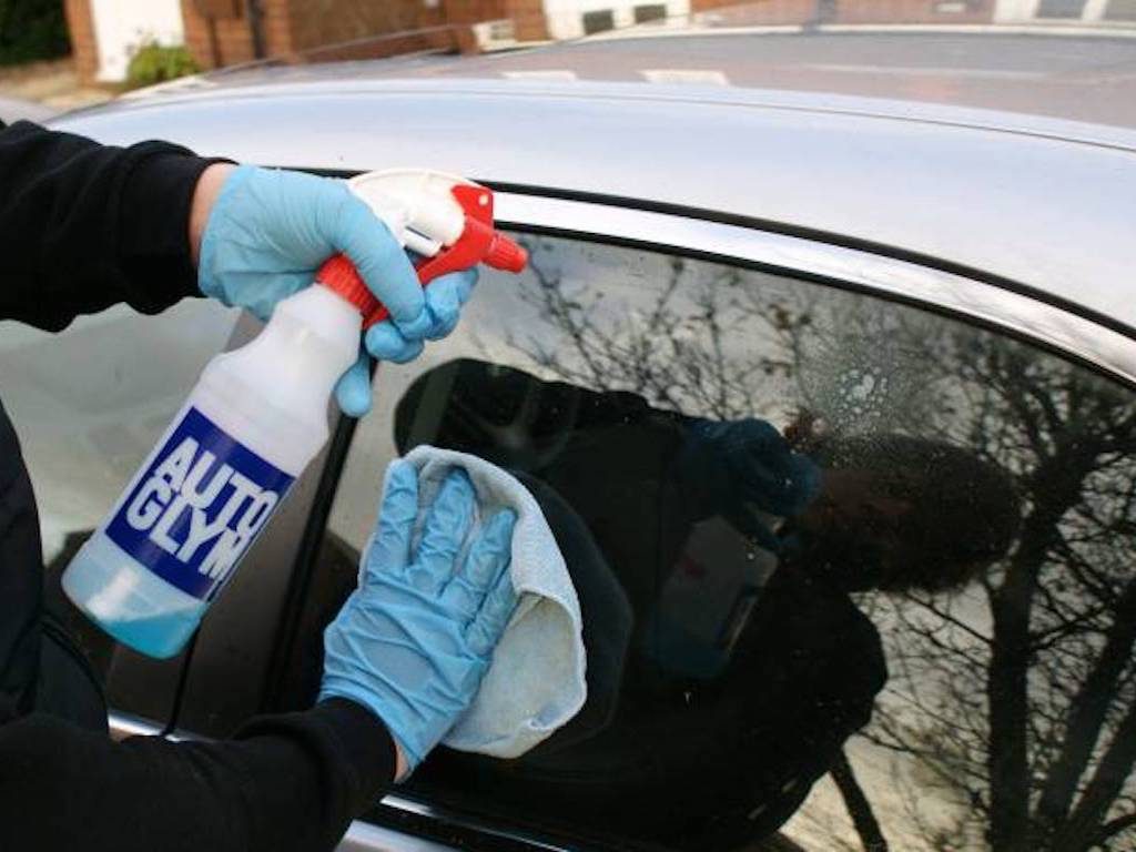 cleaning windows with autoglym bottle shown. mmvaleting provide car valeting and detailing services throughout Buckinghamshire.